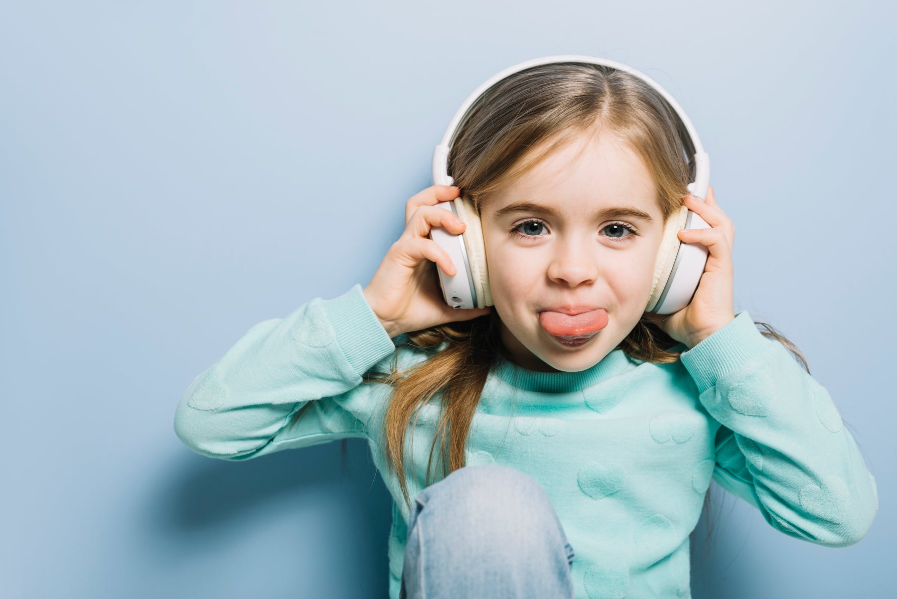 Young child wearing over-ear hearing protection headphones, illustrating the importance of protecting children’s ears from loud noises and preventing noise-induced hearing loss.