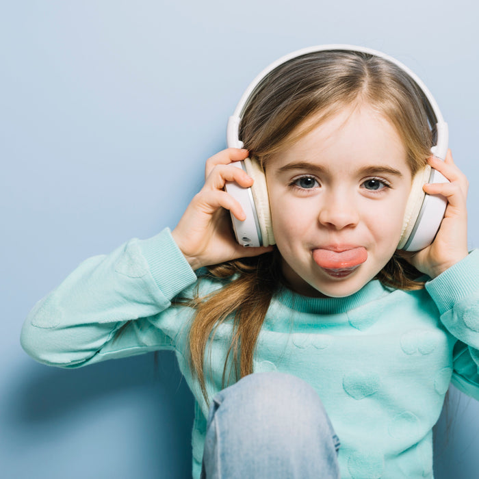 Young child wearing over-ear hearing protection headphones, illustrating the importance of protecting children’s ears from loud noises and preventing noise-induced hearing loss.