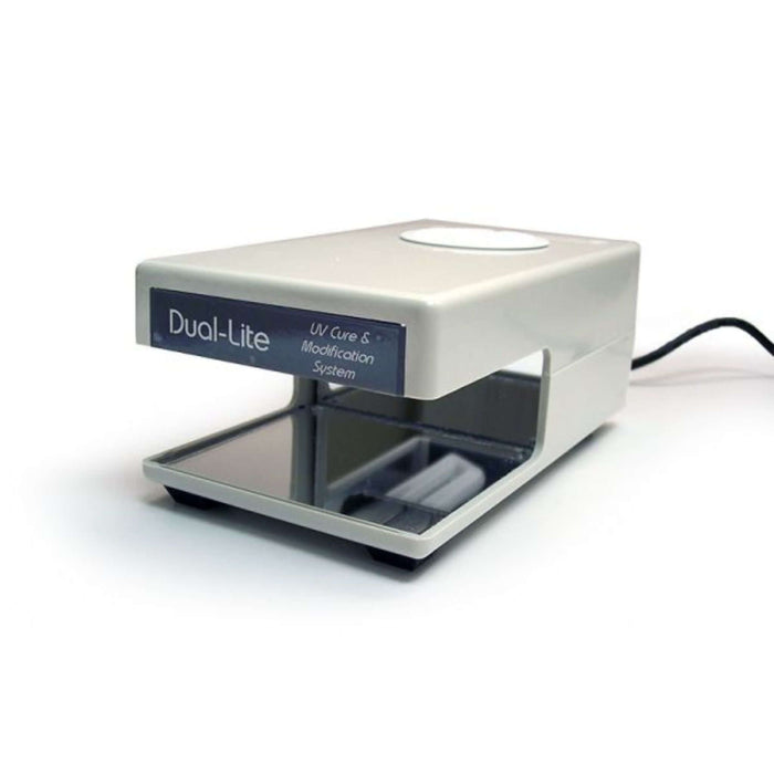 Dual-Lite UV Repair Light on a workstation with a compact design for curing hearing aid materials.